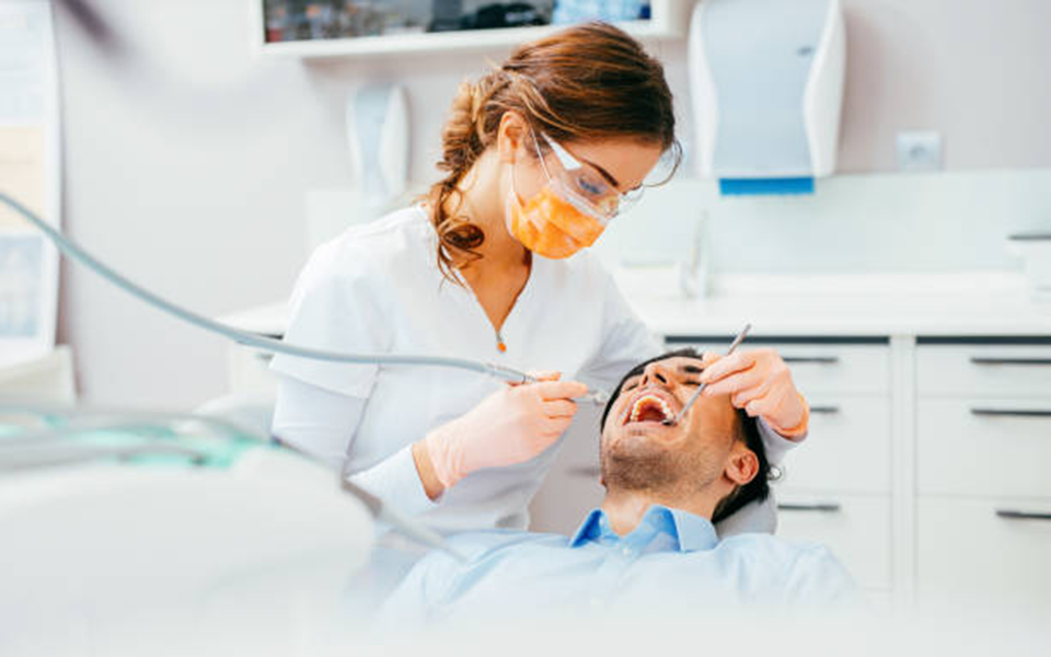 dental hygienist cleaning teeth