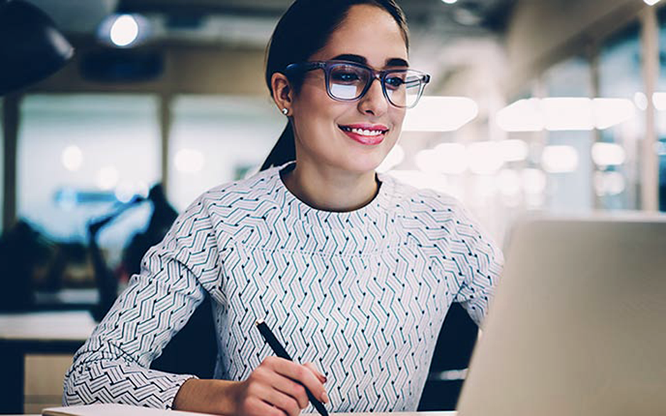 Female in office with a laptop