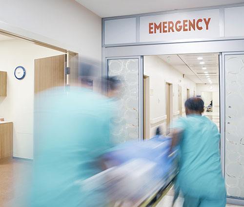 Image of doctors rushing patient into the emergency department