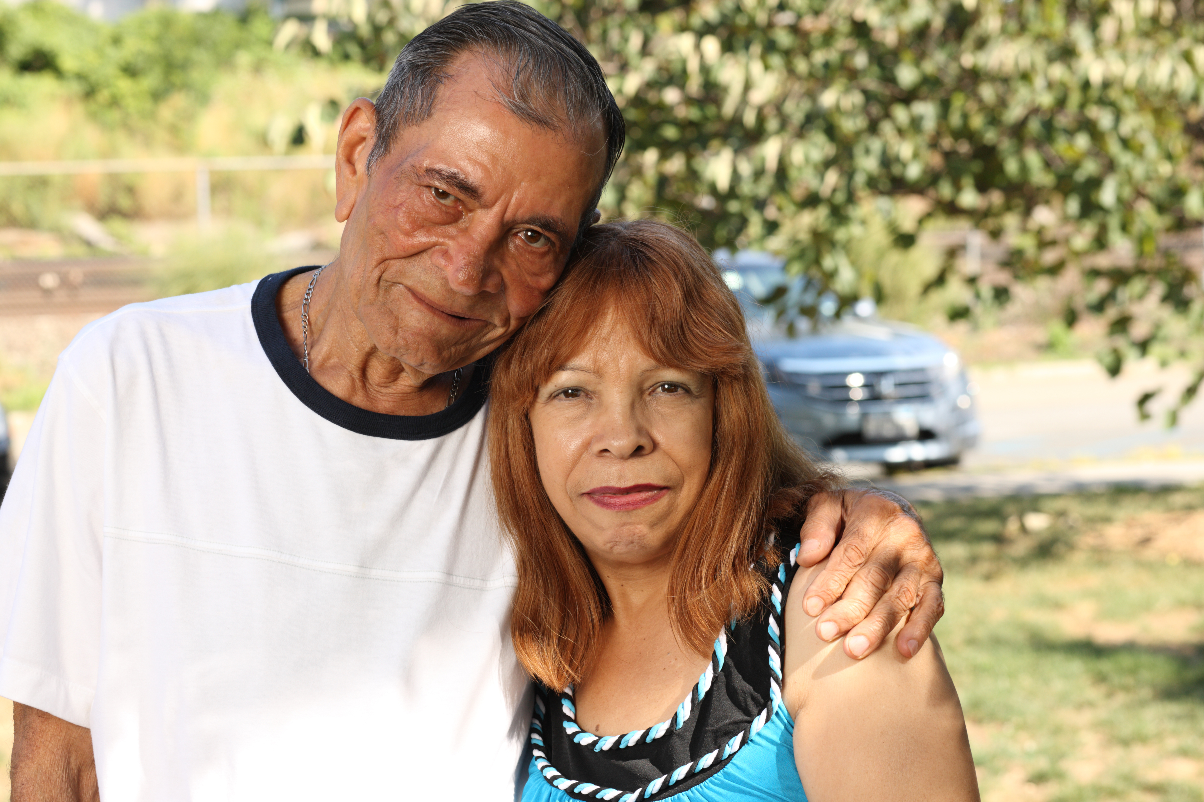 Man with his arm around a woman.