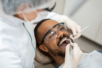 Dentist looks at patient's mouth