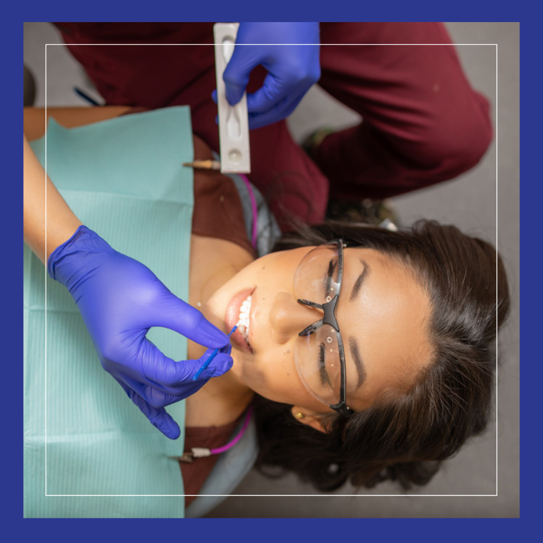 Brush on treatment. Woman getting fluoride varnish..