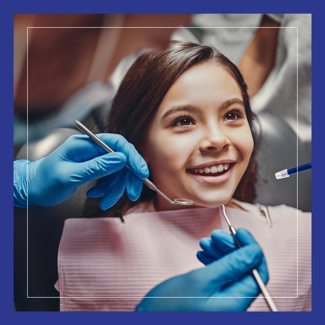 Young girl smiling, people holding dental instruments. 