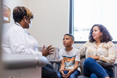 Doctor talking to child and parent