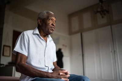 Senior man sits in chair