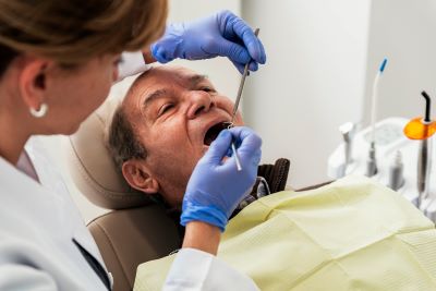 Senior man gets dental cleaning