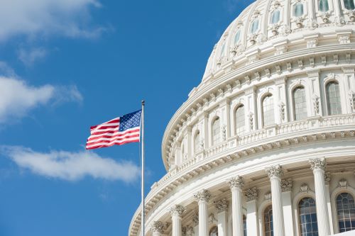 US Congress building with American flag waving