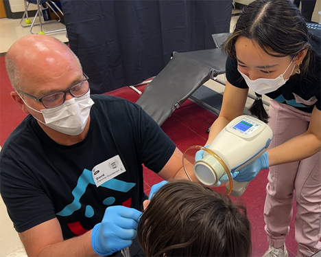 More Smiles Wisconsin team examines student's teeth