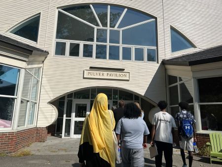 NMPHI junior community health workers walking into building
