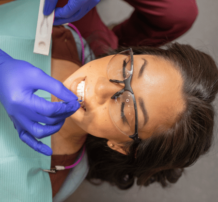 "Woman gets fluoride varnish applied"