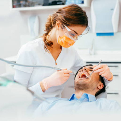 dental hygienist cleaning teeth
