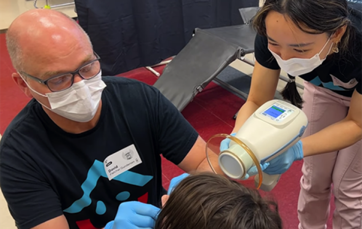 More Smiles Wisconsin team examines student's teeth