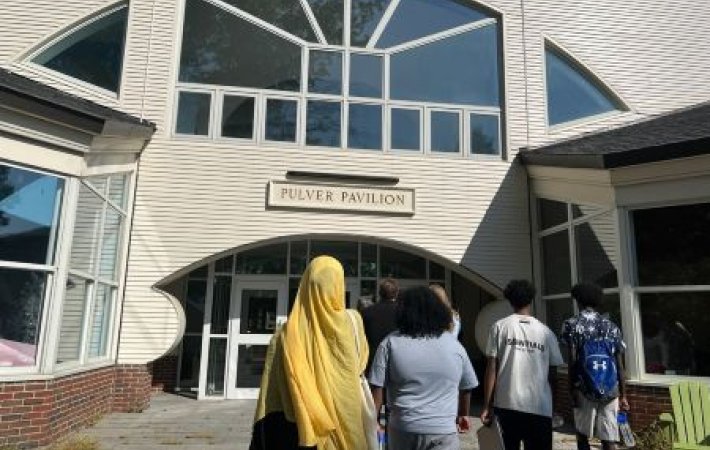 NMPHI junior community health workers walking into building