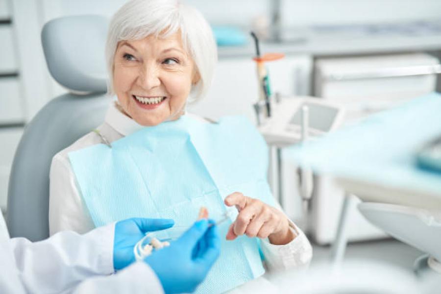female retiree in dental examination chair