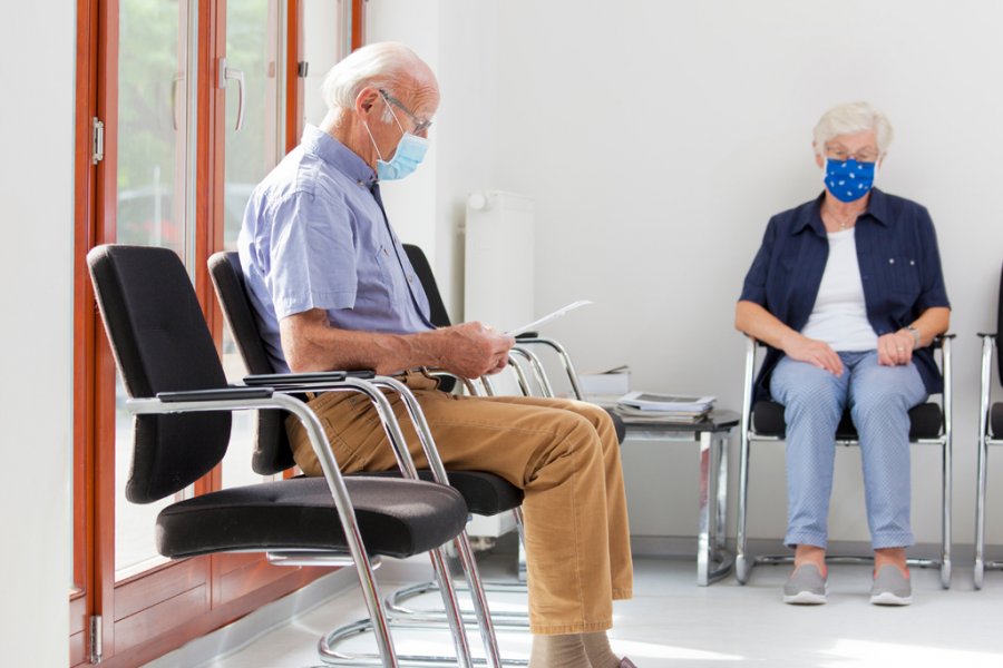 Female and male retiree patients in provider waiting room
