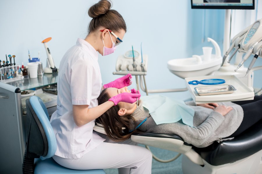 Dental Hygienist cleaning a child's teeth