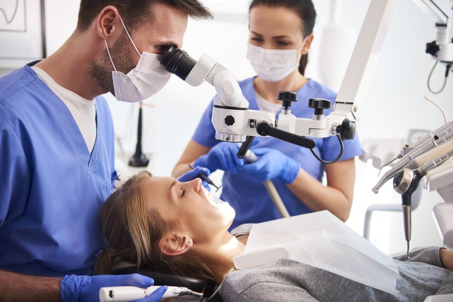 patient in dental examination chair with provider