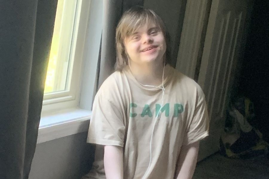 Joshua sitting on the floor at his house